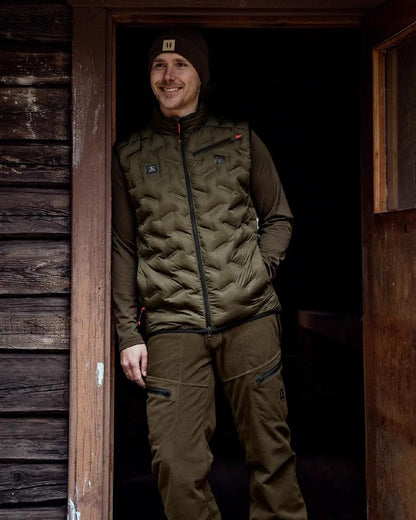 Willow Green Coloured Harkila Clim8 Insulated Waistcoat on outdoor background #colour_willow-green