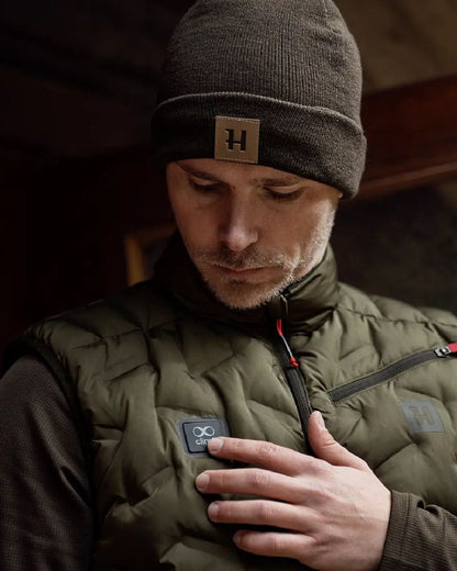 Willow Green Coloured Harkila Clim8 Insulated Waistcoat on outdoor background #colour_willow-green