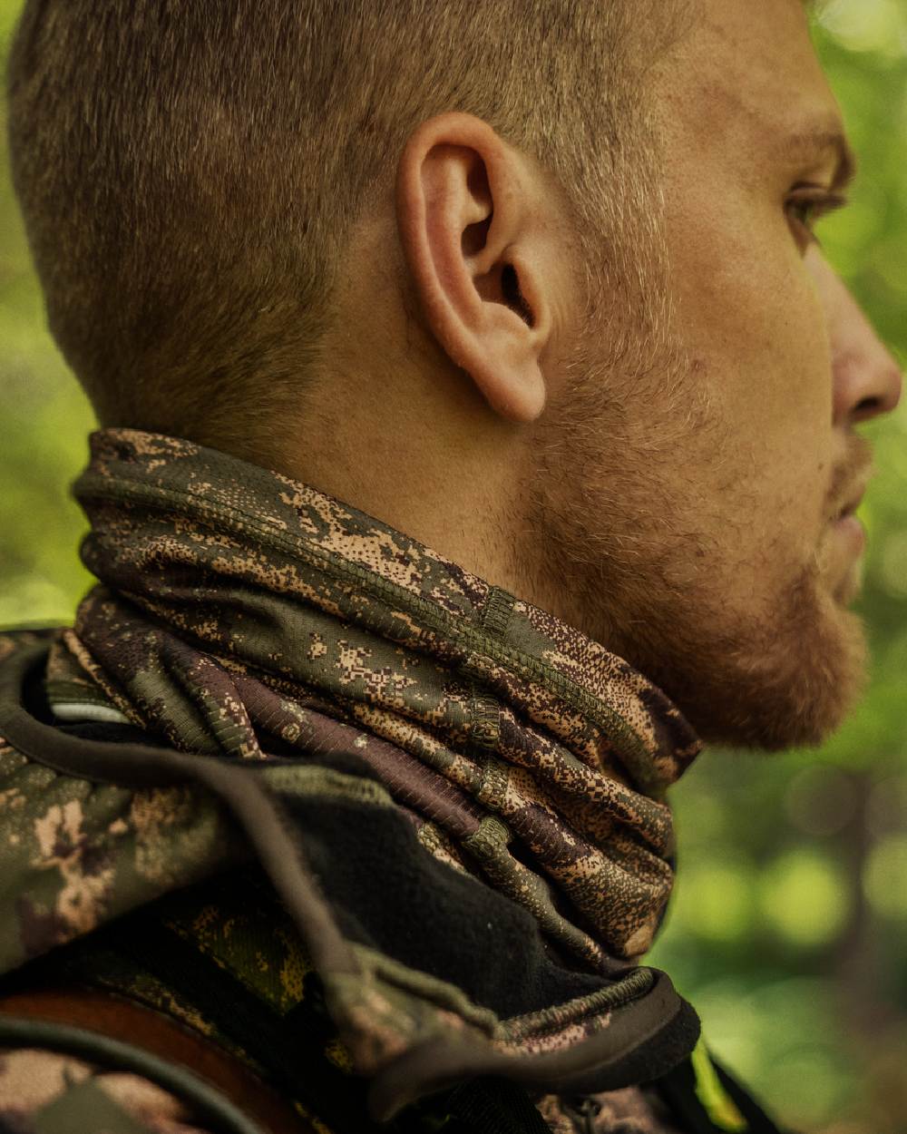 AXIS Forest Coloured Harkila Deer Stalker Camo Neck Gaiter on blurry background #colour_axis-forest