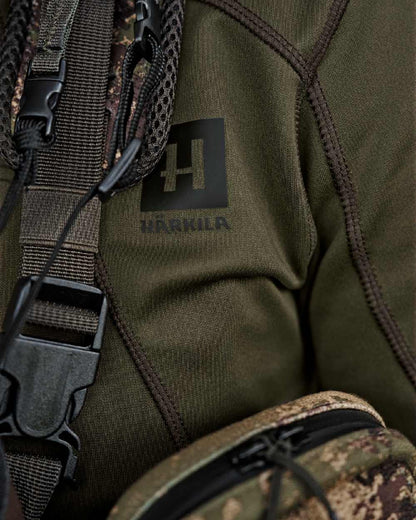 Willow Green Coloured Harkila Deer Stalker Full Zip Fleece Hoodie on blurry background #colour_willow-green