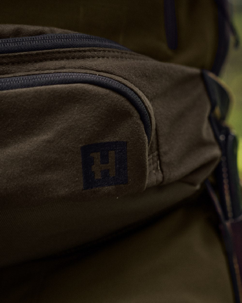 Willow Green Coloured Harkila Deer Stalker Waist Pack on outdoor background #colour_willow-green