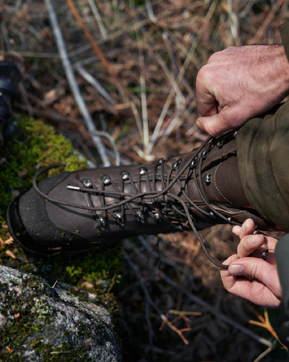 Dark Brown Coloured Harkila Driven Hunt 2.0 GTX Boots on outdoor background #colour_dark-brown