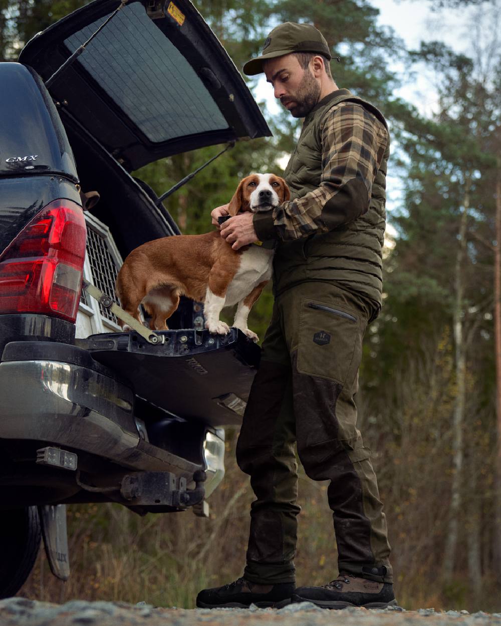 Willow Green Shadow Brown Coloured Harkila Driven Hunt HWS Leather Trousers on forest background #colour_willow-green-shadow-brown