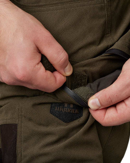 Willow Green Shadow Brown Coloured Harkila Driven Hunt HWS Leather Trousers on white background #colour_willow-green-shadow-brown