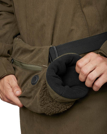 Willow Green Coloured Harkila Driven Hunt Heat Muff on white background #colour_willow-green