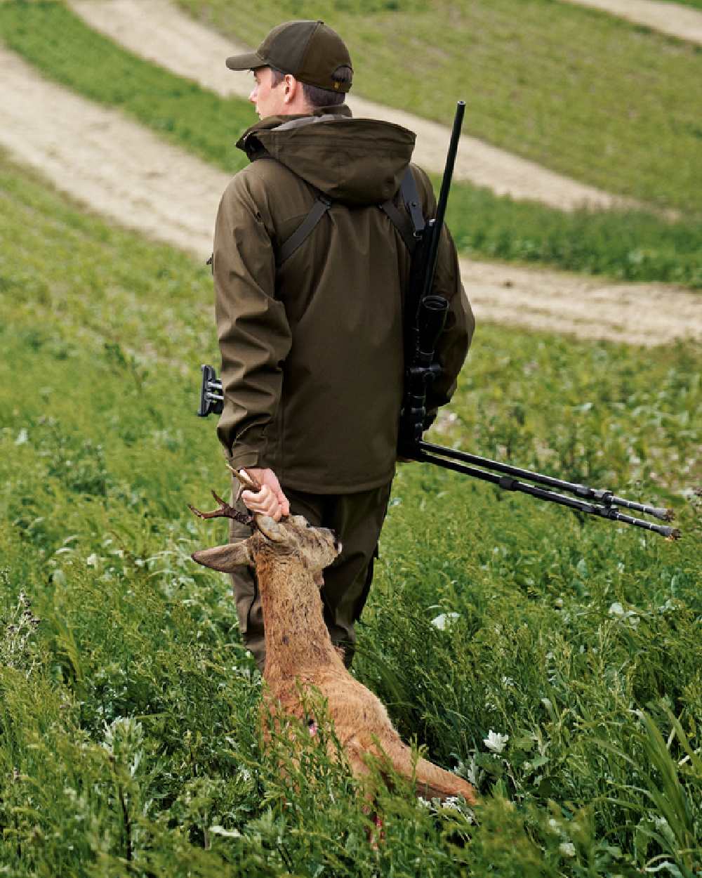 Hunting Green Coloured Harkila Finnmark HWS Jacket on forest background #colour_hunting-green