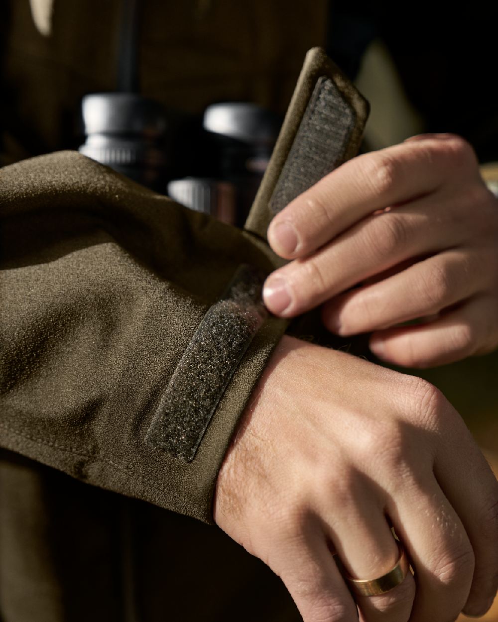 Hunting Green Coloured Harkila Finnmark HWS Jacket on blurry background #colour_hunting-green
