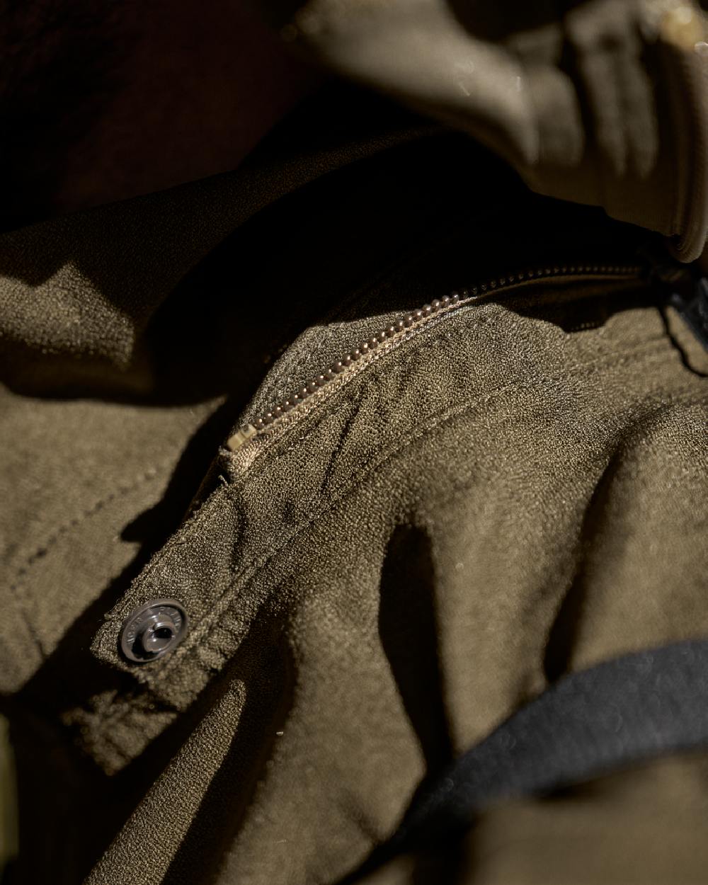 Hunting Green Coloured Harkila Finnmark HWS Jacket on blurry background #colour_hunting-green