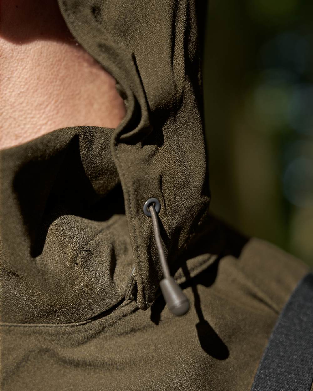 Hunting Green Coloured Harkila Finnmark HWS Jacket on blurry background #colour_hunting-green
