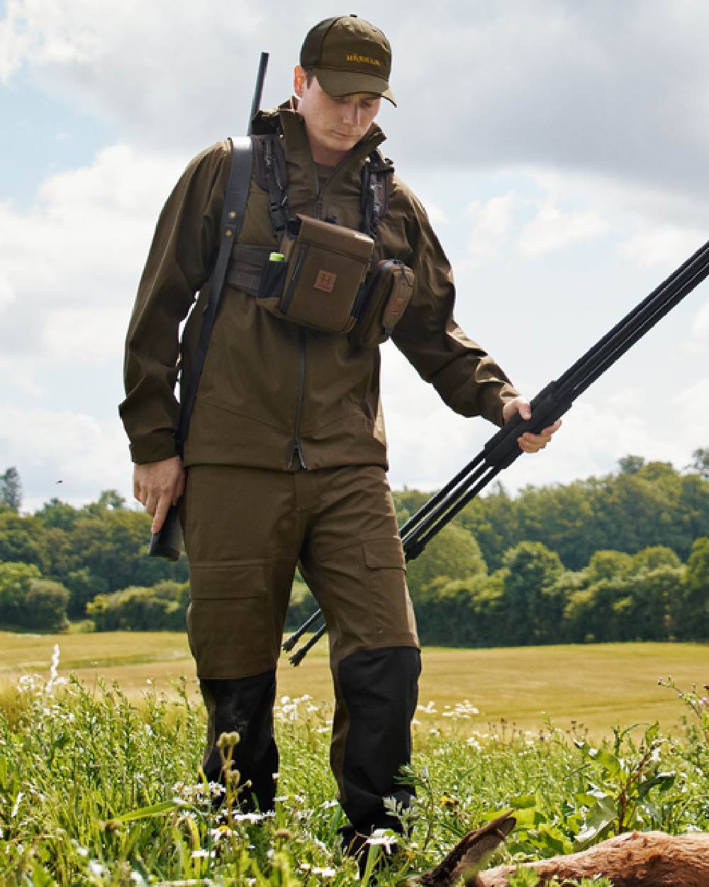 Hunting Green Coloured Harkila Finnmark HWS Trousers on forest background #colour_hunting-green