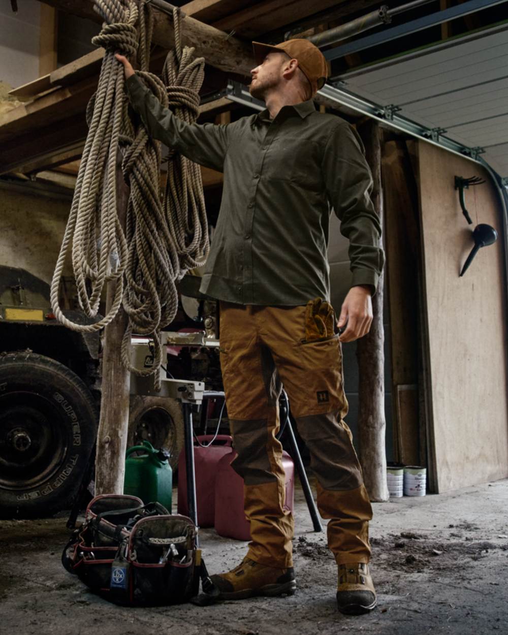 Rustique Clay Brown Coloured Harkila Fjell Trousers on factory background #colour_rustique-clay-brown