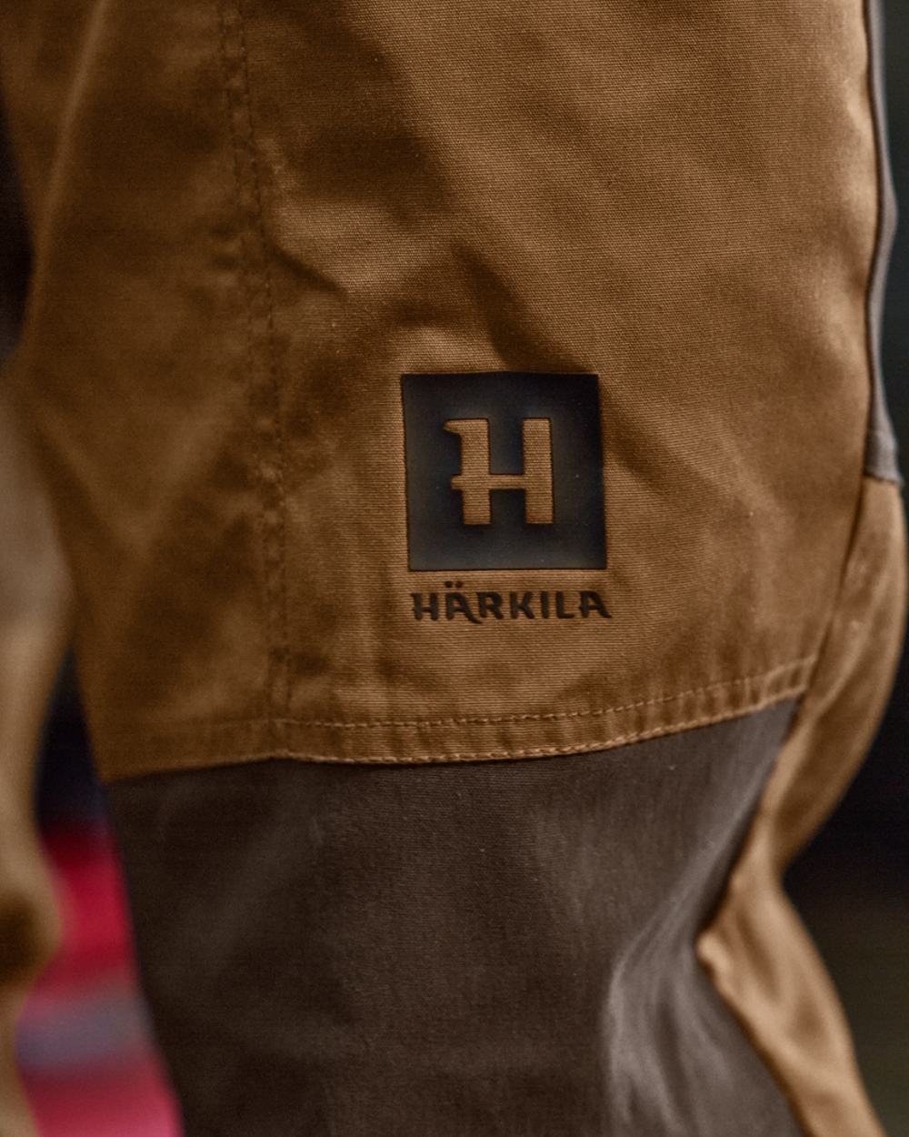 Rustique Clay Brown Coloured Harkila Fjell Trousers on factory background #colour_rustique-clay-brown