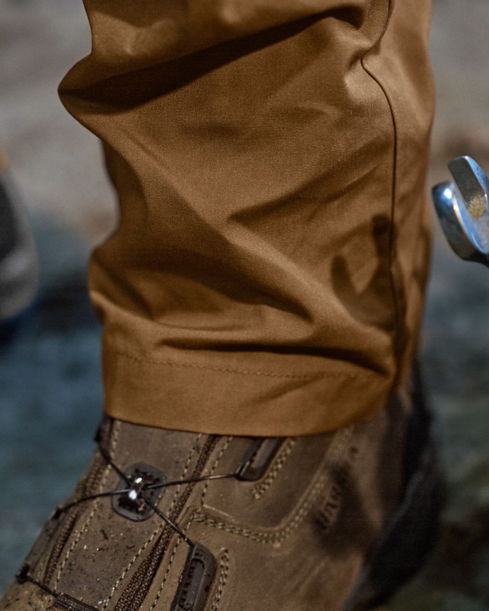 Rustique Clay Brown Coloured Harkila Fjell Trousers on factory background #colour_rustique-clay-brown