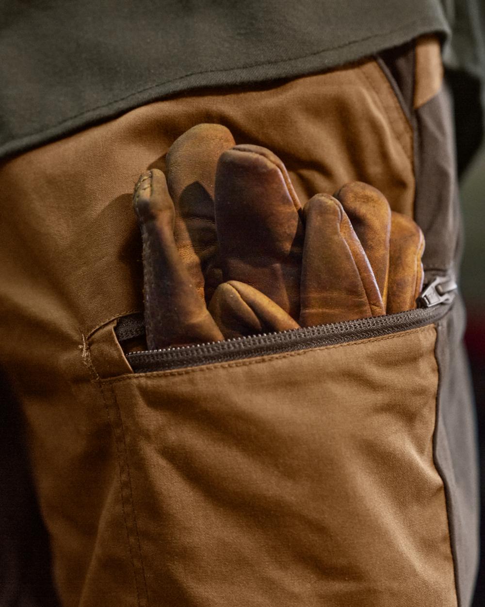 Rustique Clay Brown Coloured Harkila Fjell Trousers on factory background #colour_rustique-clay-brown