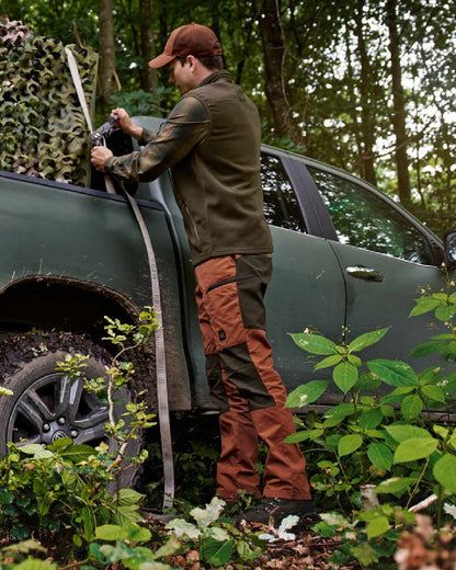 Shadow Brown Arabian Spice Coloured Harkila Fjell Trousers on forest background #colour_shadow-brown-arabian-spice