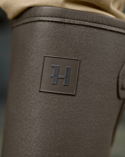 Dark Willow Green Coloured Harkila Forester Gusset Rubber Boots on outdoor background #colour_dark-willow-green