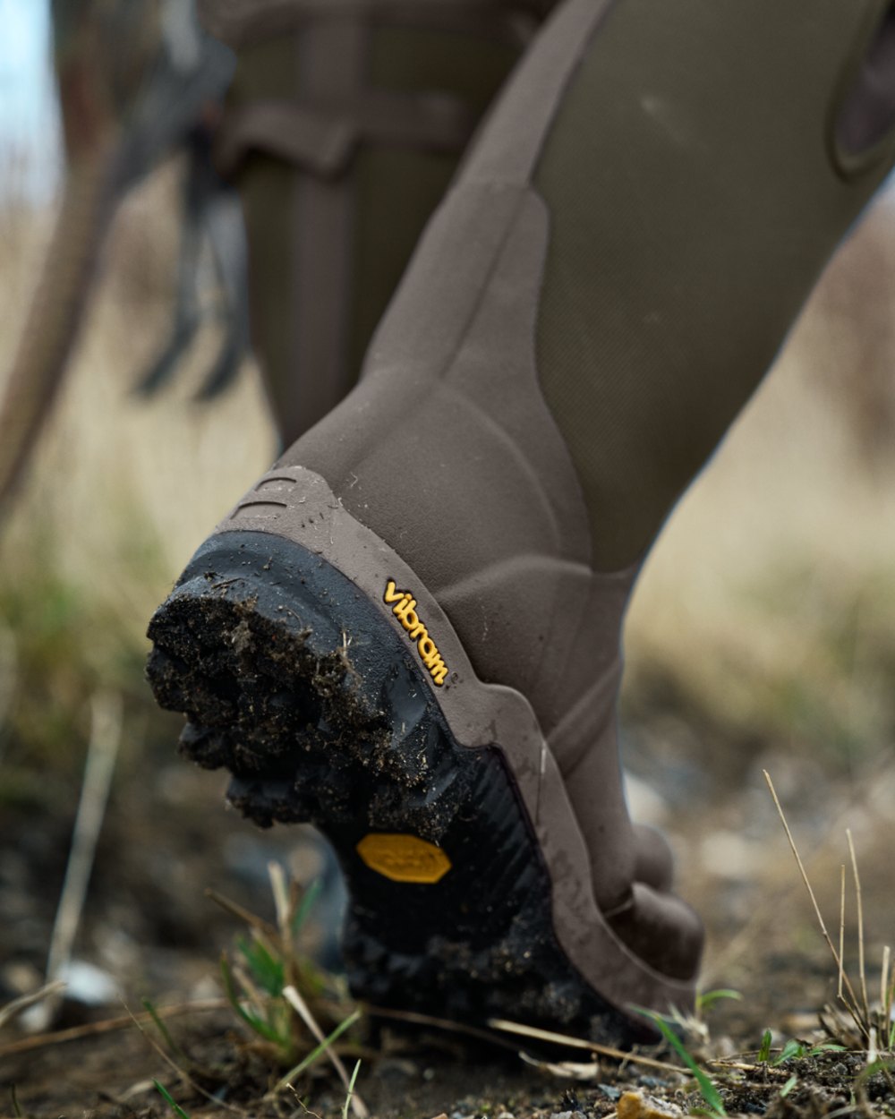 Willow Green Deep Brown Coloured Harkila Forester Zip Rubber Boot on outdoor background #colour_willow-green-deep-brown