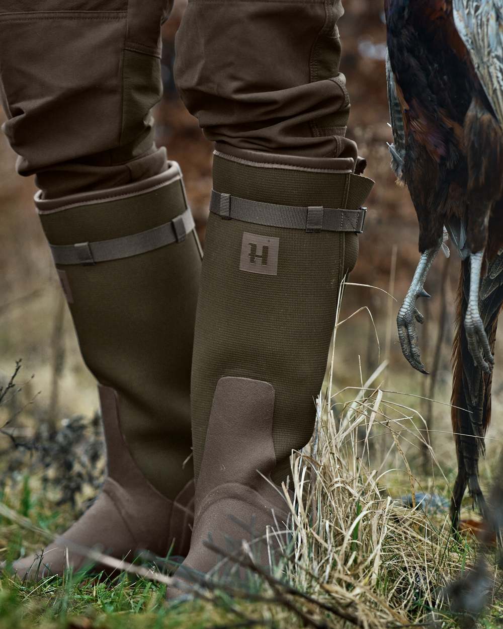 Willow Green Deep Brown Coloured Harkila Forester Zip Rubber Boot on outdoor background #colour_willow-green-deep-brown