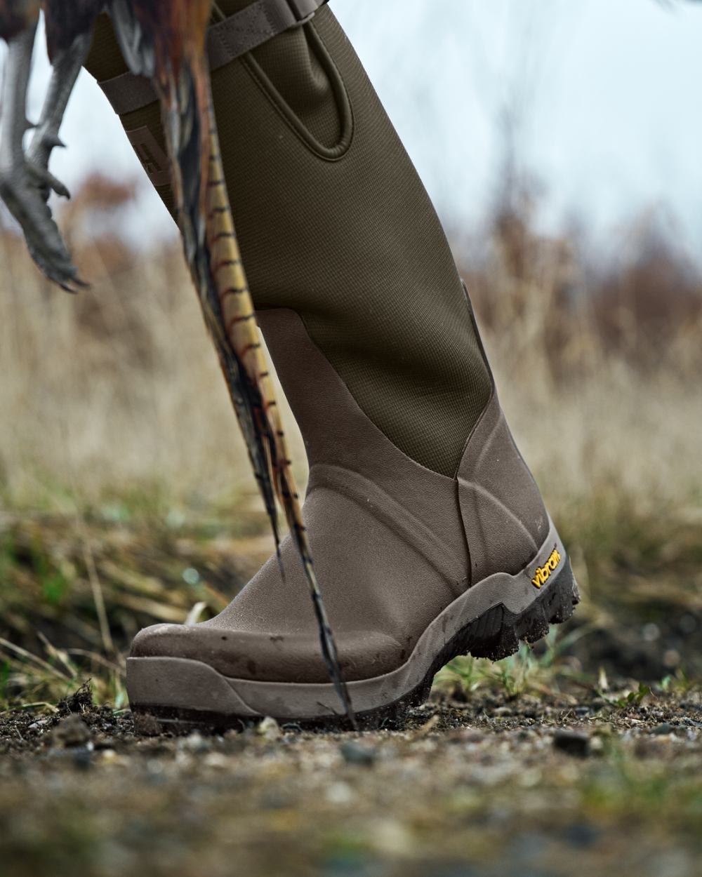 Willow Green Deep Brown Coloured Harkila Forester Zip Rubber Boot on outdoor background #colour_willow-green-deep-brown