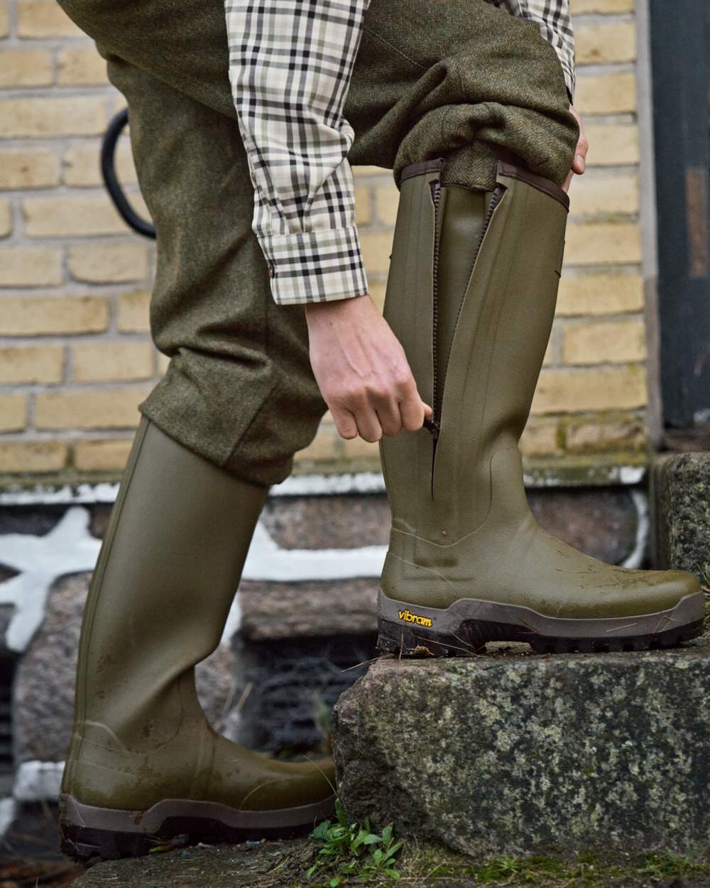Dark Olive Coloured Harkila Forester Zip Rubber Boot on outdoor background #colour_dark-olive