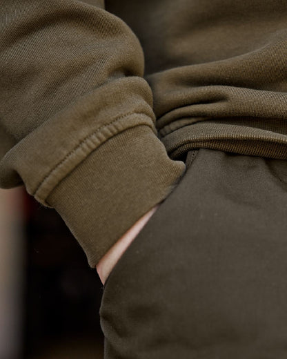 Light Willow Green Coloured Harkila Instinct Sweatshirt on blurry background #colour_light-willow-green