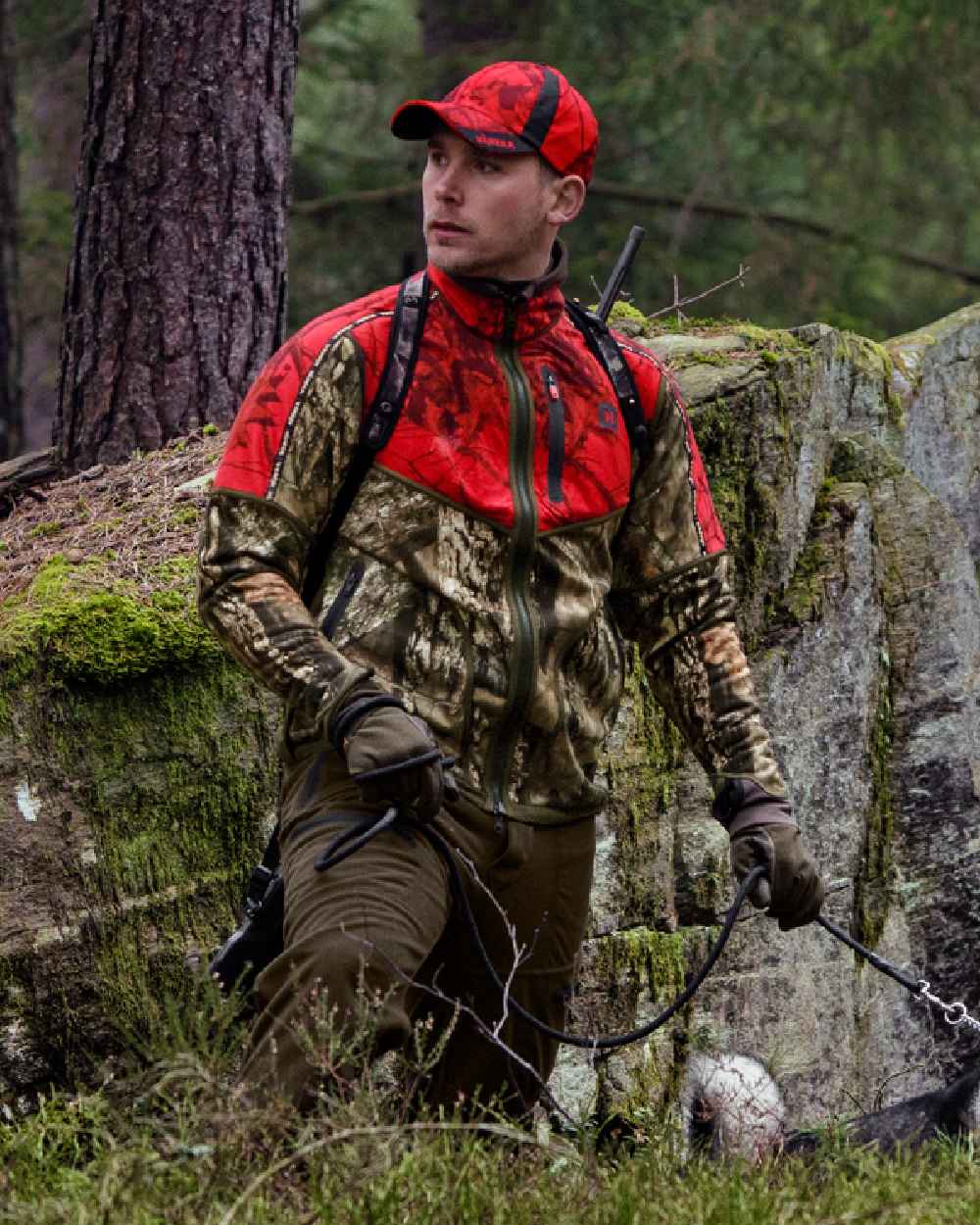 Hunting Green Mossy Oak Break-up Country Coloured Harkila Kamko Camo Reversible WSP Jacket on forest background #colour_hunting-green-mossy-oak-break-up-country