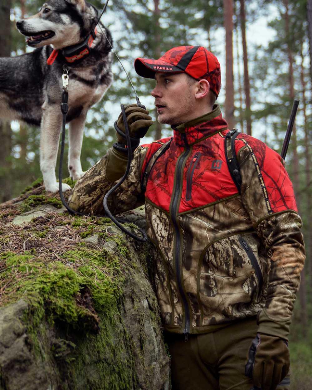 Hunting Green Mossy Oak Break-up Country Coloured Harkila Kamko Camo Reversible WSP Jacket on forest background #colour_hunting-green-mossy-oak-break-up-country