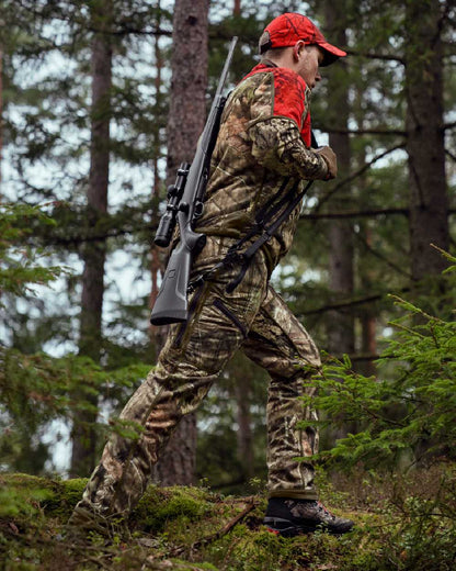 Hunting Green Mossy Oak Break-up Country Coloured Harkila Kamko Camo Reversible WSP Jacket on forest background #colour_hunting-green-mossy-oak-break-up-country