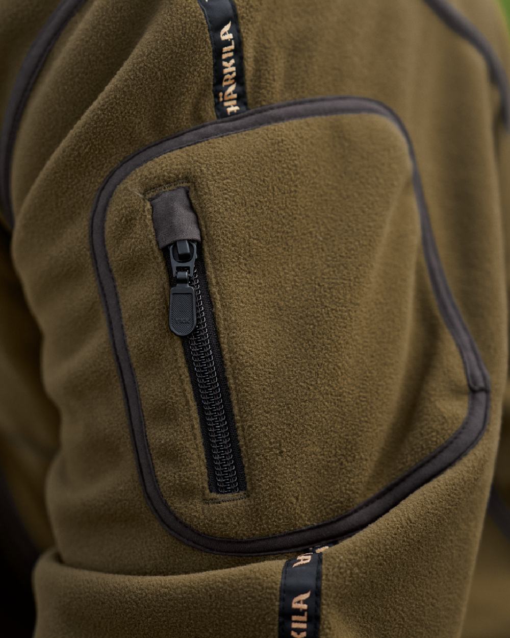 Dark Olive Arabian Spice Coloured Harkila Kamko Fleece on outdoor background #colour_dark-olive-arabian-spice