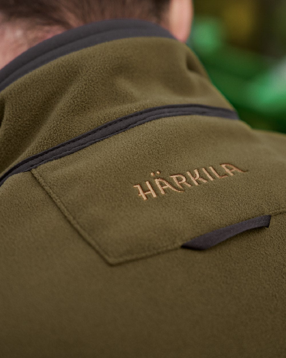 Dark Olive Arabian Spice Coloured Harkila Kamko Fleece on outdoor background #colour_dark-olive-arabian-spice