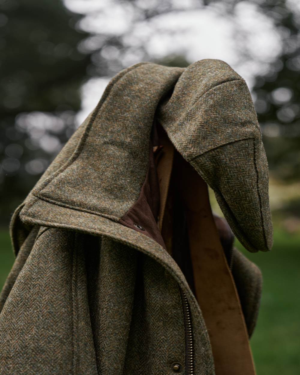 Forest Green Herringbone Coloured Harkila Kenmore Classic Flat Cap on outdoor background #colour_forest-green-herringbone