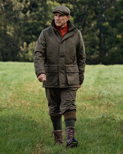 Forest Green Herringbone coloured Harkila Kenmore GTX Breeks on forest background #colour_forest-green-herringbone