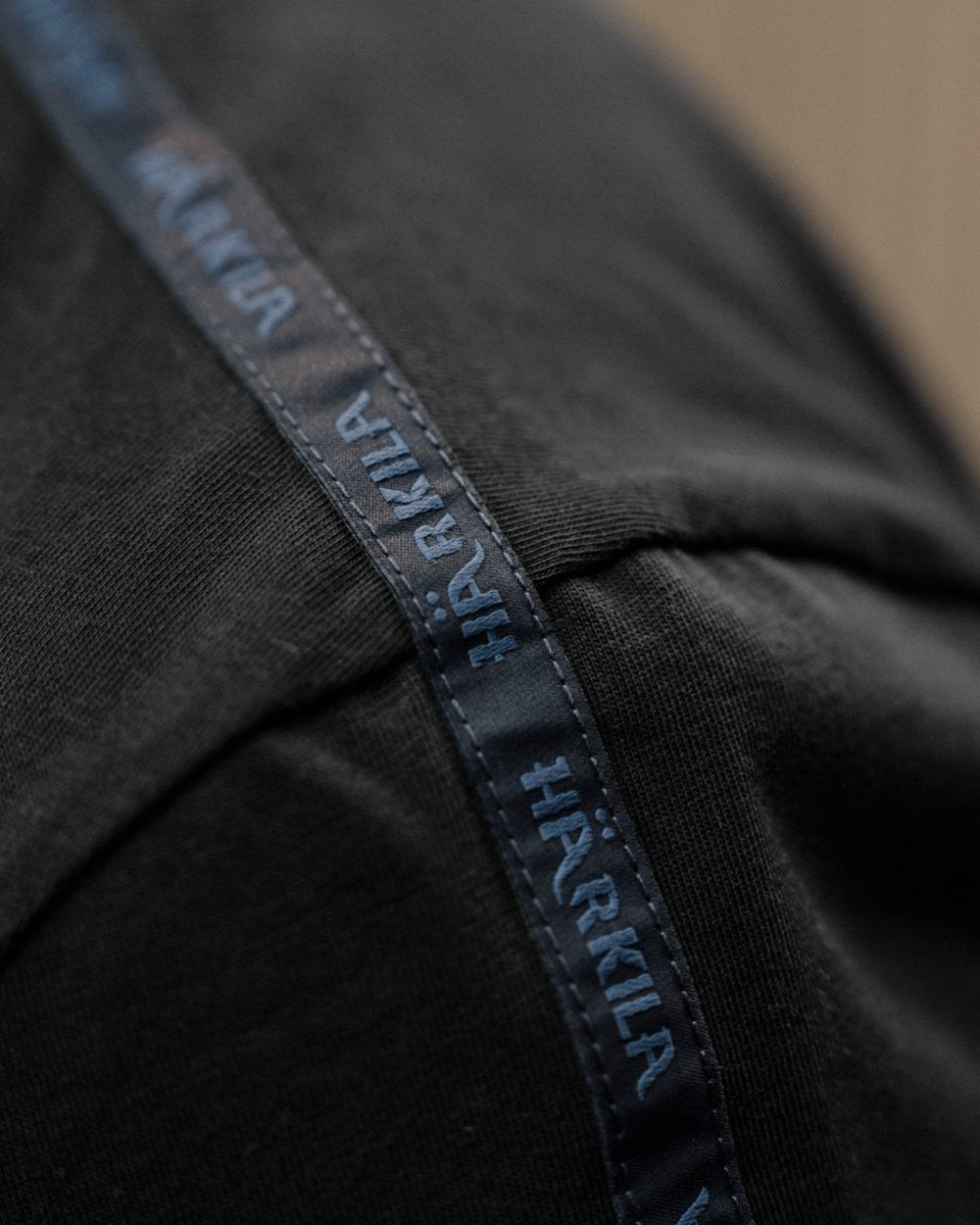 Shadow Brown/Tarmac coloured Harkila Logo Band Short Sleeve T-Shirt on outdoor background #colour_shadow-brown-tarmac