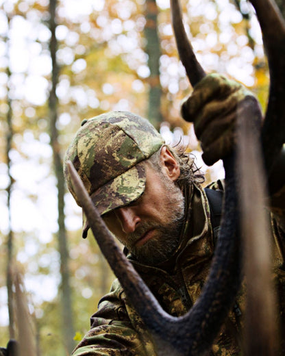 Axis MSP Forest Coloured Harkila Lynx Cap on forest background #colour_axis-msp-forest