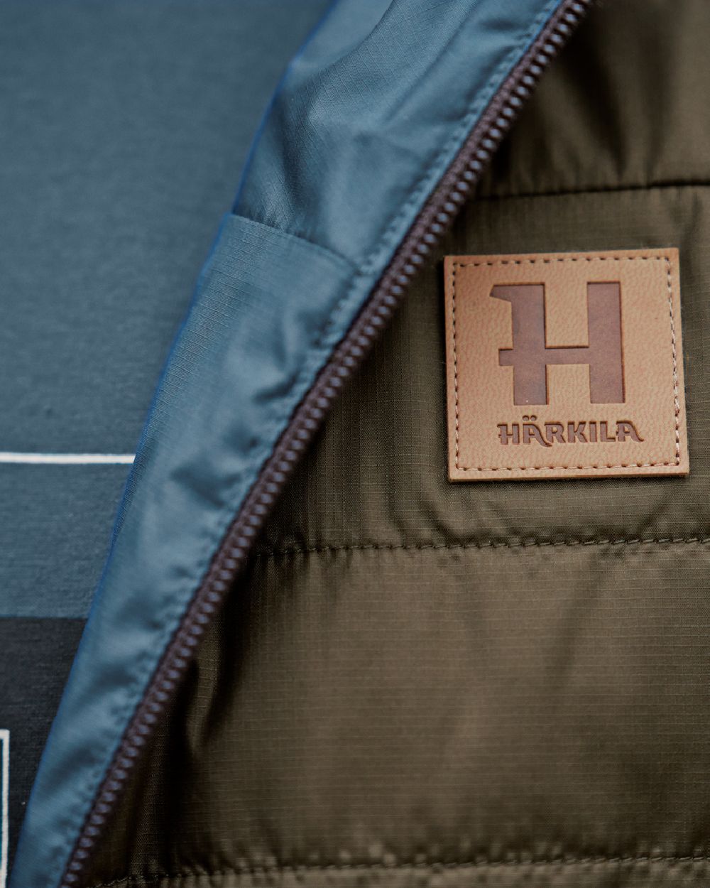Willow Green Sea Blue Coloured Harkila Mens Kalix HSP Jacket on blurry background #colour_willow-green-sea-blue