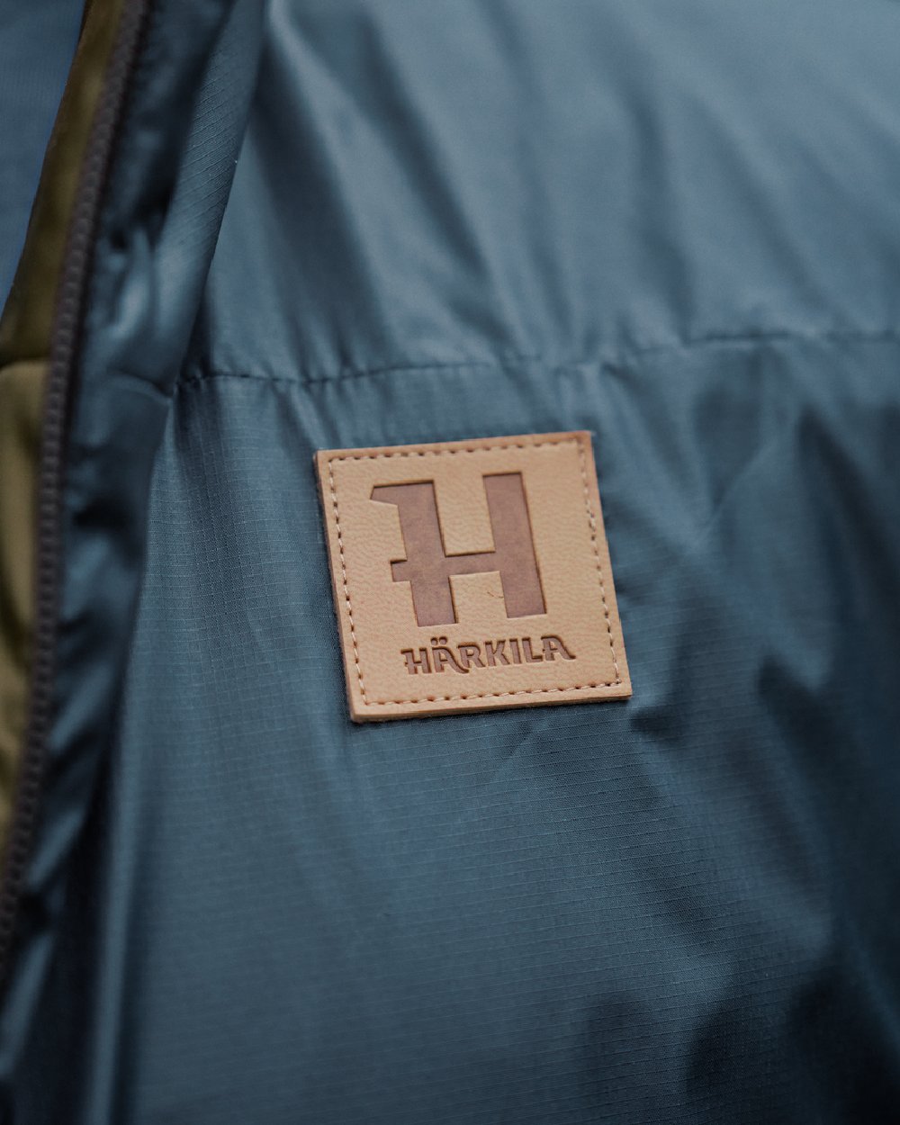 Willow Green Sea Blue Coloured Harkila Mens Kalix HSP Jacket on blurry background #colour_willow-green-sea-blue
