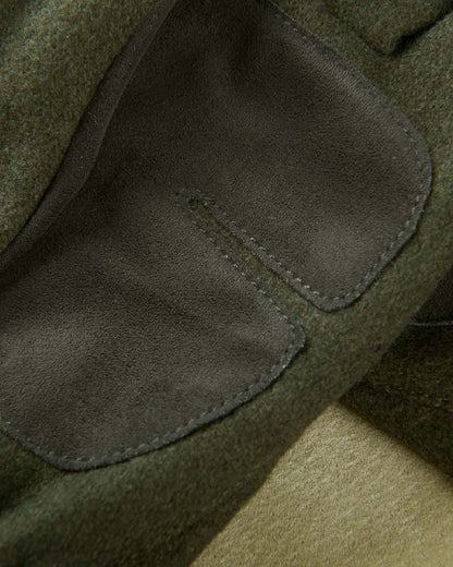 Willow Green Coloured Harkila Metso Active Gloves on blurry background #colour_willow-green