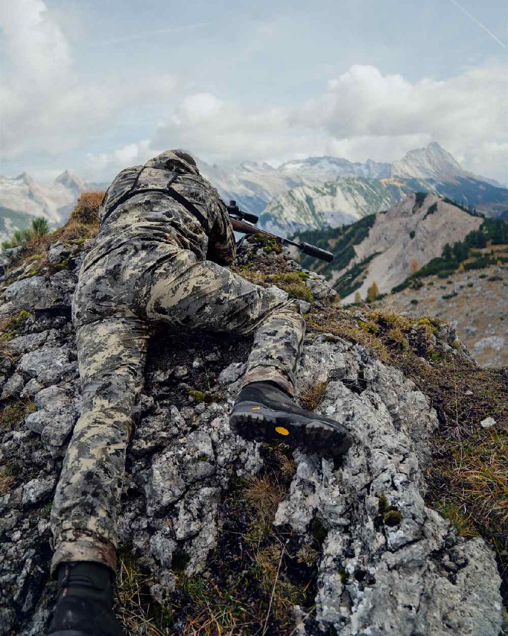 AXIS Mountain Coloured Harkila Mountain Hunter Expedition HWS Packable Trousers on mountain background #colour_axis-mountain