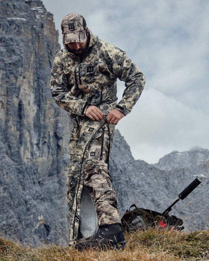 AXIS Mountain Coloured Harkila Mountain Hunter Expedition HWS Packable Trousers on mountain background #colour_axis-mountain