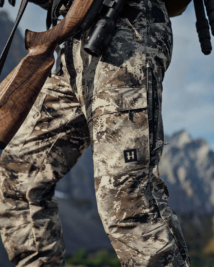AXIS Mountain Coloured Harkila Mountain Hunter Expedition Light Trousers on outdoor background #colour_axis-mountain