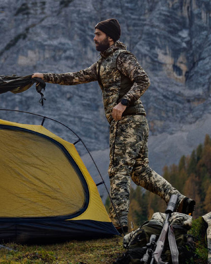 AXIS Mountain Shadow Brown Coloured Harkila Mountain Hunter Expedition Reversible Down Waistcoat on mountain background #colour_axis-mountain-shadow-brown