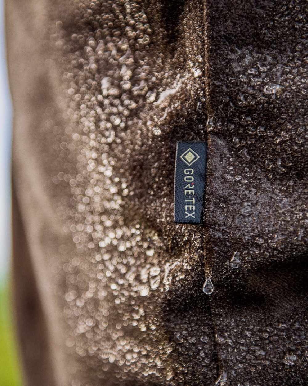 Hunting Green Shadow Brown Coloured Harkila Mountain Hunter Trousers on outdoor background #colour_hunting-green-shadow-brown