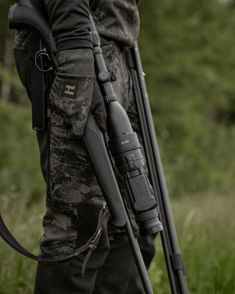 AXIS Black Black Coloured Harkila NOCTYX Camo Silent Trousers on outdoor background #colour_axis-black-black