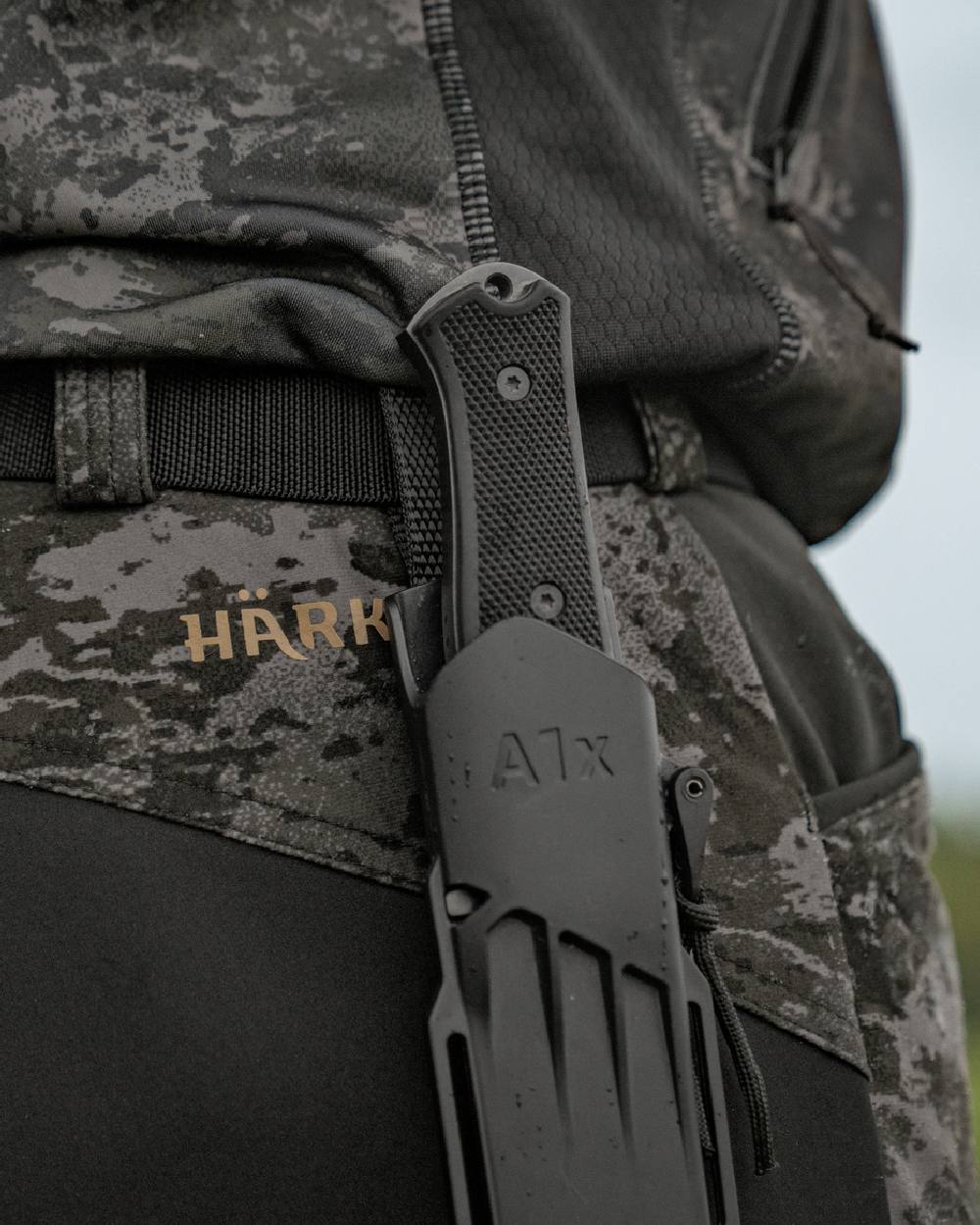 AXIS Black Black Coloured Harkila NOCTYX Camo Silent Trousers on outdoor background #colour_axis-black-black
