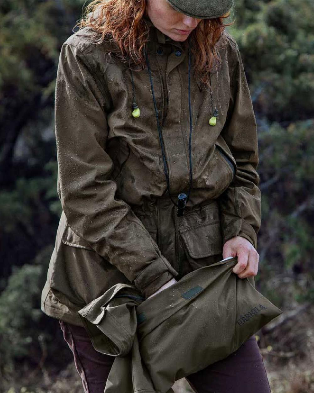 Willow Green Coloured Harkila Orton Packable Lady Jacket on outdoor background #colour_willow-green