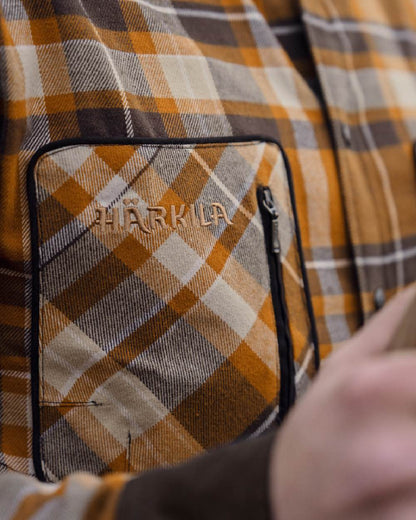 Cornstalk Check coloured Harkila Pajala Check Shirt on field background #colour_cornstalk-check