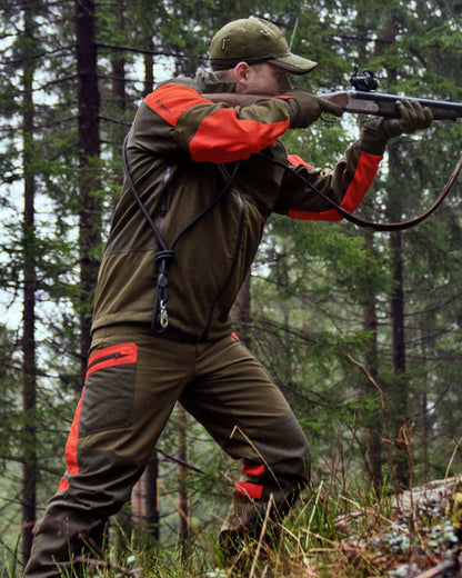 Willow Green Orange Coloured Harkila Pro Hunter Dog Keeper GTX Jacket on outdoor background #colour_willow-green-orange