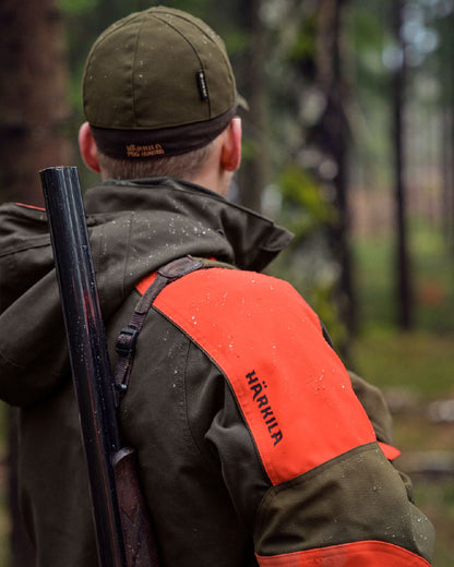 Willow Green Orange Coloured Harkila Pro Hunter Dog Keeper GTX Jacket on outdoor background #colour_willow-green-orange
