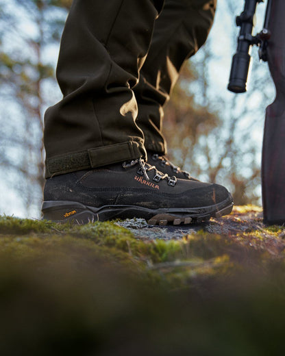 Shadow Brown Coloured Harkila Pro Hunter Light Mid GTX Boots on outdoor background #colour_shadow-brown