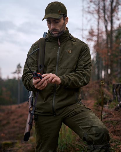 Willow Green Coloured Harkila Pro Hunter Move 2.0 GTX Jacket on outdoor background #colour_willow-green